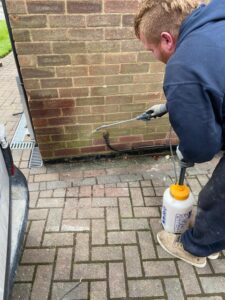 Waterproof wall sealant being used to stop a garage from flooding